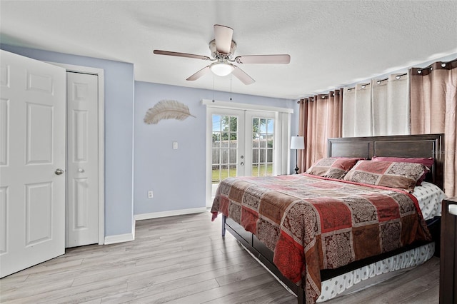 bedroom featuring access to outside, french doors, wood finished floors, and a ceiling fan
