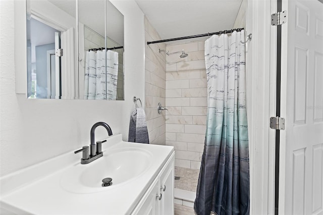 bathroom with a stall shower and vanity
