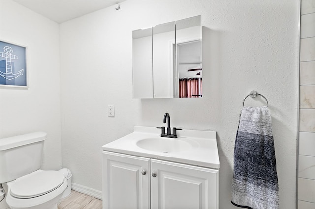 half bath with vanity and wood finished floors