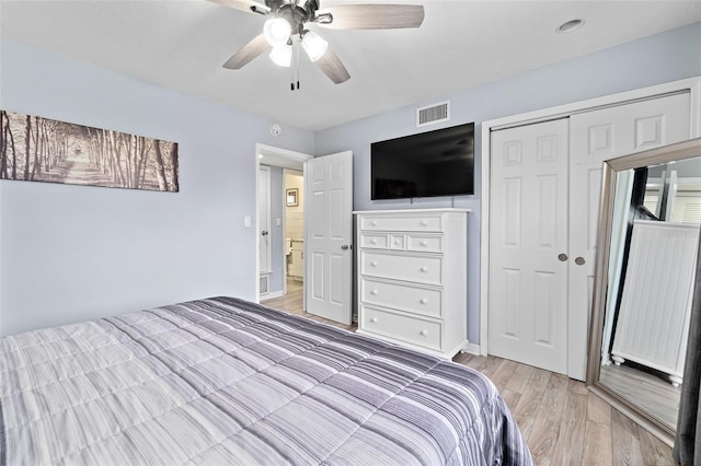 bedroom featuring light wood-style flooring, a closet, and ceiling fan