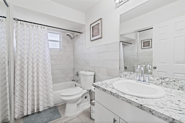 full bath with tile walls, vanity, and shower / bathtub combination with curtain