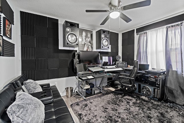 home office with a ceiling fan and wood finished floors