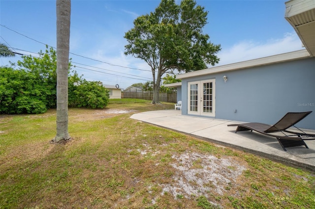 view of yard with french doors and a patio area