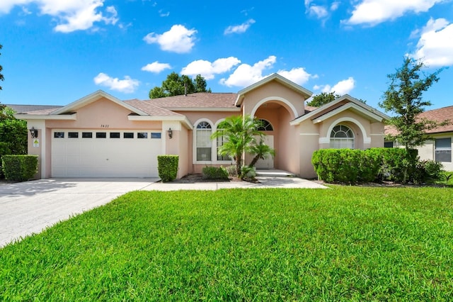 3422 Swallow Hill St, Clermont, FL 34714 - view of front of home with stucco siding, an attached garage, a front lawn, and driveway