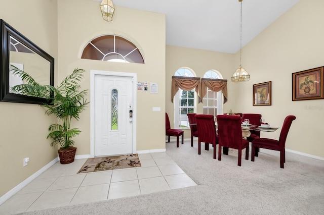 3422 Swallow Hill St, Clermont, FL 34714 - tiled entryway with high vaulted ceiling, a chandelier, and carpet floors