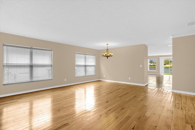 15175 Sugargrove Way, Orlando, FL 32828 - spare room featuring a chandelier and light wood-style floors
