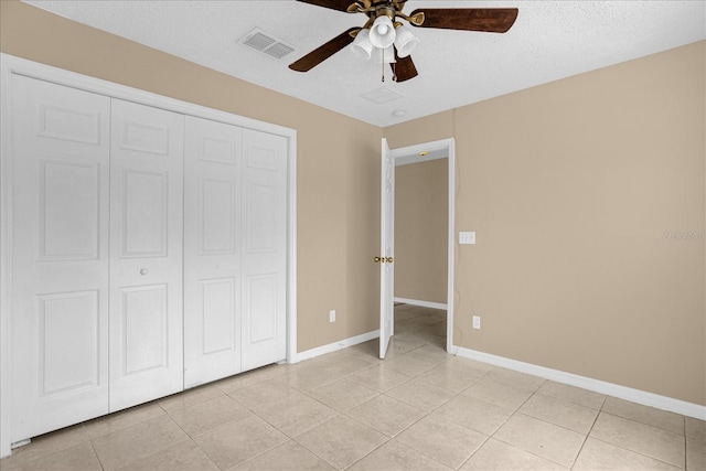 15175 Sugargrove Way, Orlando, FL 32828 - unfurnished bedroom featuring light tile patterned floors, a closet, a ceiling fan, and a textured ceiling