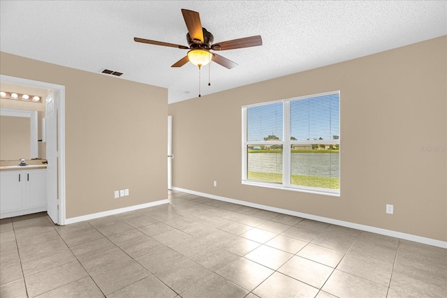 15175 Sugargrove Way, Orlando, FL 32828 - empty room with light tile patterned floors, ceiling fan, and a textured ceiling