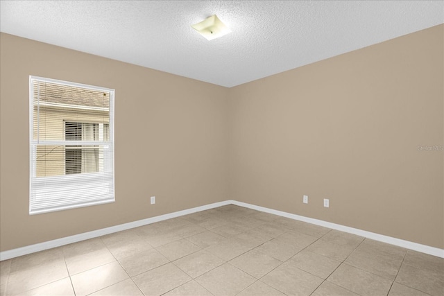 15175 Sugargrove Way, Orlando, FL 32828 - spare room with a textured ceiling and light tile patterned flooring
