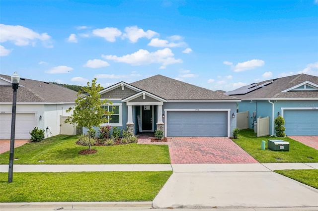 2936 Wild Mulberry Dr, Clermont, FL 34711 - view of front of home featuring stucco siding, a garage, decorative driveway, and a front yard
