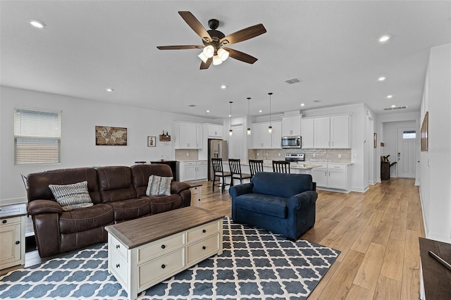 2936 Wild Mulberry Dr, Clermont, FL 34711 - living room with a ceiling fan, light wood finished floors, recessed lighting, and plenty of natural light