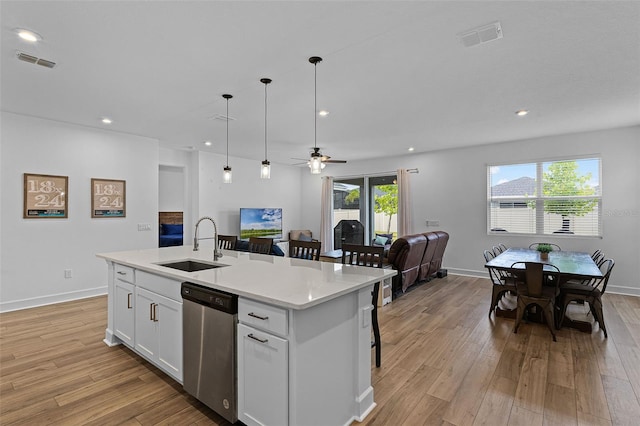 2936 Wild Mulberry Dr, Clermont, FL 34711 - kitchen featuring dishwasher, open floor plan, a center island with sink, light wood-style floors, and recessed lighting