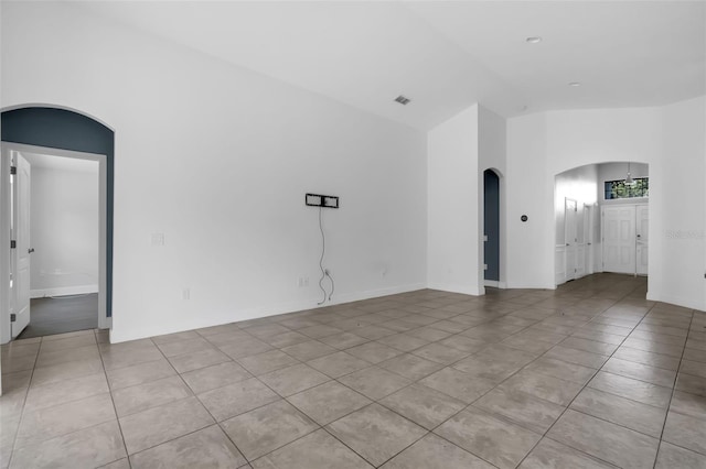 305 Chelmsford Ct, Kissimmee, FL 34758 - spare room with arched walkways, light tile patterned floors, and high vaulted ceiling