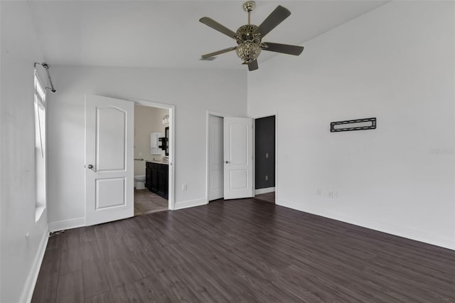 305 Chelmsford Ct, Kissimmee, FL 34758 - unfurnished bedroom featuring lofted ceiling, dark wood-style flooring, ensuite bath, and ceiling fan