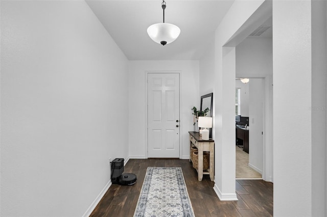 17242 Hickory Wind Dr, Clermont, FL 34711 - entrance foyer featuring dark wood-type flooring and baseboards