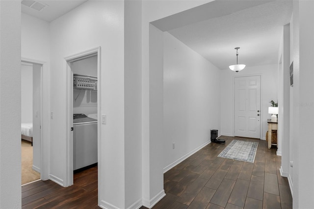 17242 Hickory Wind Dr, Clermont, FL 34711 - foyer featuring dark wood-style flooring and washer and clothes dryer