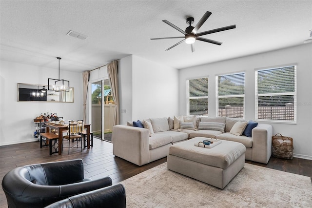 17242 Hickory Wind Dr, Clermont, FL 34711 - living room featuring dark wood finished floors, a chandelier, ceiling fan, and a textured ceiling