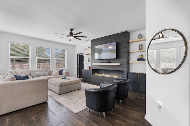 17242 Hickory Wind Dr, Clermont, FL 34711 - living area with ceiling fan, a large fireplace, dark wood finished floors, and a textured ceiling