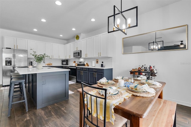 17242 Hickory Wind Dr, Clermont, FL 34711 - kitchen with stainless steel appliances, recessed lighting, white cabinets, light countertops, and a center island