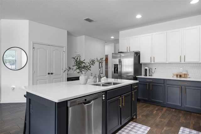 17242 Hickory Wind Dr, Clermont, FL 34711 - kitchen with appliances with stainless steel finishes, dark wood-style flooring, light countertops, recessed lighting, and white cabinetry