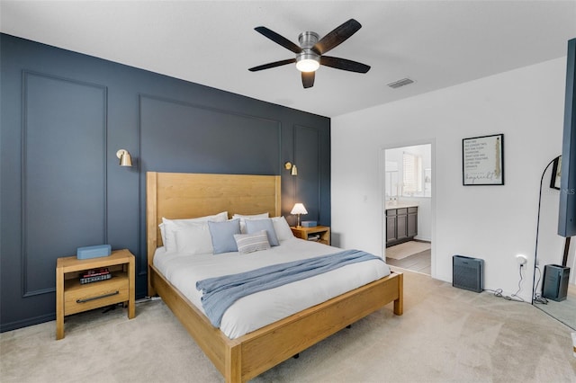 17242 Hickory Wind Dr, Clermont, FL 34711 - bedroom with light colored carpet, connected bathroom, and ceiling fan