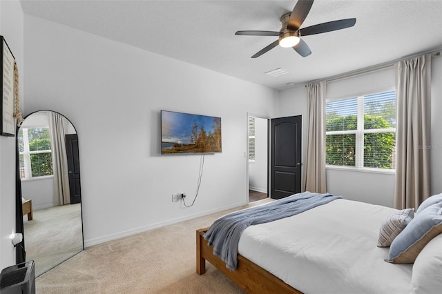 17242 Hickory Wind Dr, Clermont, FL 34711 - bedroom featuring light colored carpet, multiple windows, and a ceiling fan