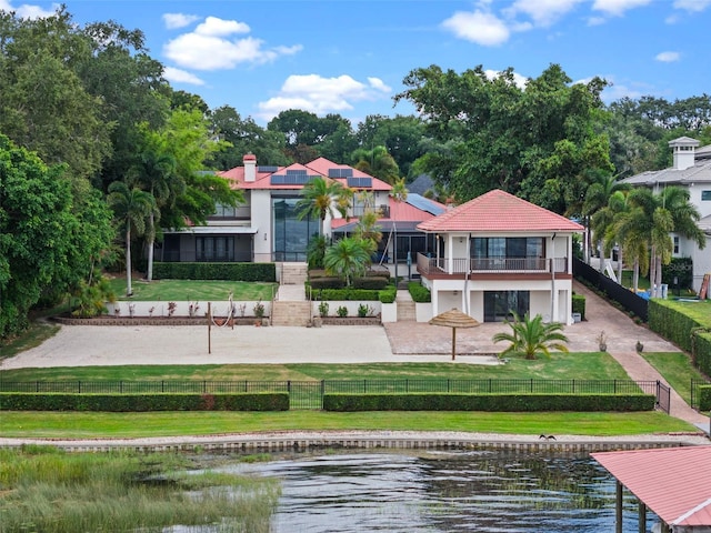 10545 Down Lakeview Cir, Windermere, FL 34786 - back of property featuring a fenced front yard, stucco siding, a balcony, a water view, and a patio
