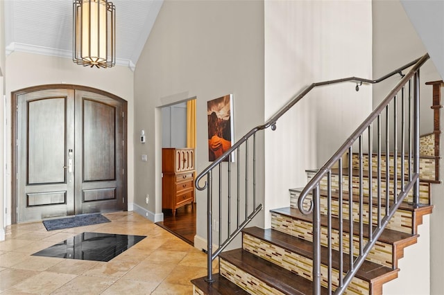10545 Down Lakeview Cir, Windermere, FL 34786 - foyer entrance featuring stairs, a high ceiling, crown molding, and arched walkways