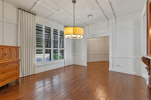 10545 Down Lakeview Cir, Windermere, FL 34786 - unfurnished dining area featuring a decorative wall, dark wood-style flooring, and coffered ceiling