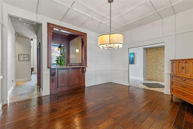 10545 Down Lakeview Cir, Windermere, FL 34786 - empty room featuring wood-type flooring, coffered ceiling, and a decorative wall