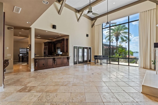 10545 Down Lakeview Cir, Windermere, FL 34786 - unfurnished living room featuring a high ceiling, stone tile floors, recessed lighting, and a ceiling fan
