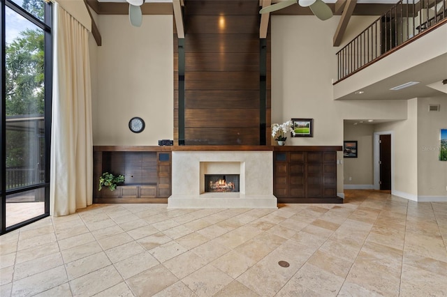 10545 Down Lakeview Cir, Windermere, FL 34786 - unfurnished living room with ceiling fan, a high ceiling, a premium fireplace, and tile patterned flooring