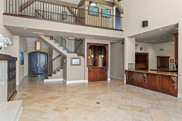 10545 Down Lakeview Cir, Windermere, FL 34786 - unfurnished living room with a towering ceiling, ceiling fan, and stairs