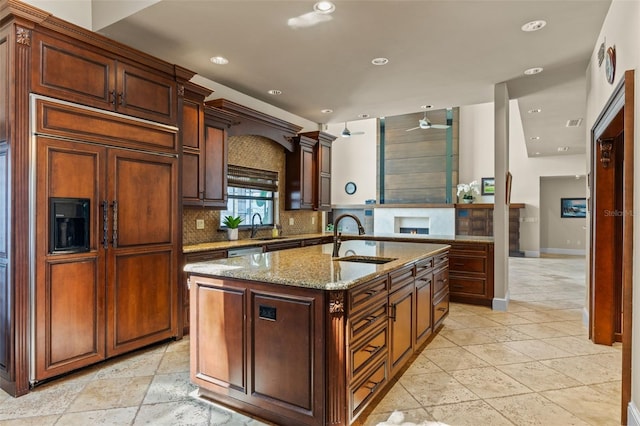 10545 Down Lakeview Cir, Windermere, FL 34786 - kitchen featuring paneled built in fridge, recessed lighting, tasteful backsplash, ceiling fan, and light stone counters