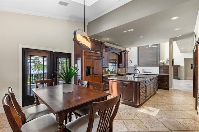 10545 Down Lakeview Cir, Windermere, FL 34786 - dining room featuring healthy amount of natural light, recessed lighting, ornamental molding, french doors, and stone tile floors
