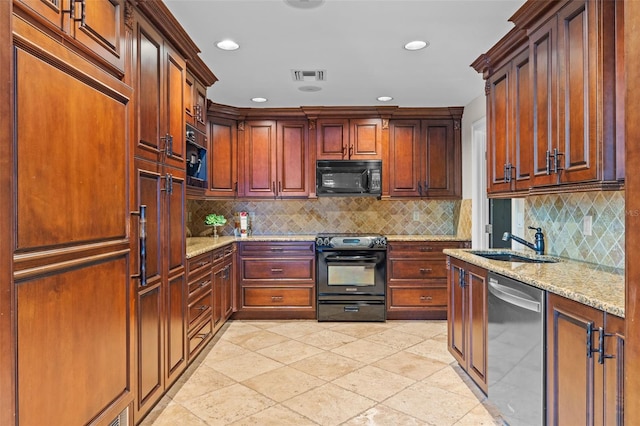 10545 Down Lakeview Cir, Windermere, FL 34786 - kitchen with black appliances, light stone countertops, recessed lighting, and decorative backsplash