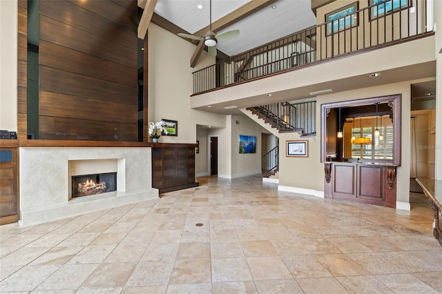 10545 Down Lakeview Cir, Windermere, FL 34786 - unfurnished living room with a towering ceiling, a ceiling fan, a fireplace, and stairs