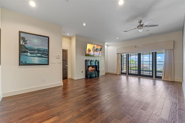 10545 Down Lakeview Cir, Windermere, FL 34786 - unfurnished living room featuring dark wood-style floors, recessed lighting, a ceiling fan, and a fireplace