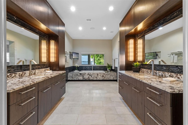 10545 Down Lakeview Cir, Windermere, FL 34786 - full bath featuring backsplash, a bath, tile patterned floors, two vanities, and recessed lighting