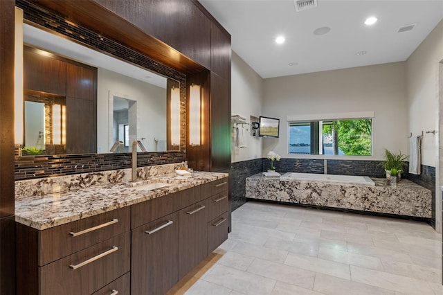 10545 Down Lakeview Cir, Windermere, FL 34786 - full bathroom with vanity, a bath, tile patterned flooring, decorative backsplash, and recessed lighting