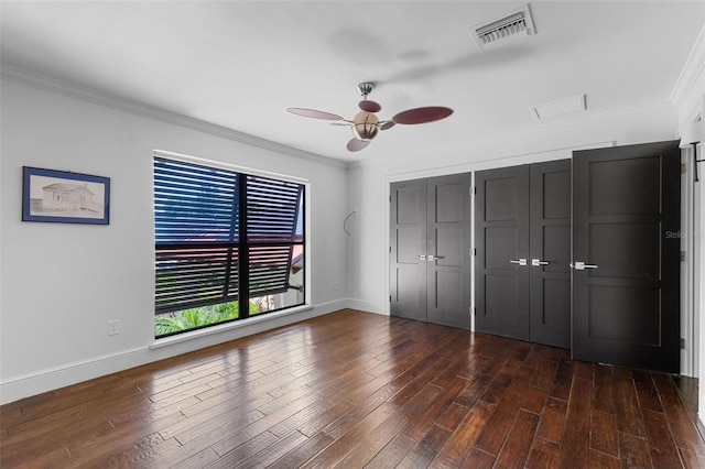 10545 Down Lakeview Cir, Windermere, FL 34786 - unfurnished bedroom with crown molding, dark wood-type flooring, a closet, and ceiling fan