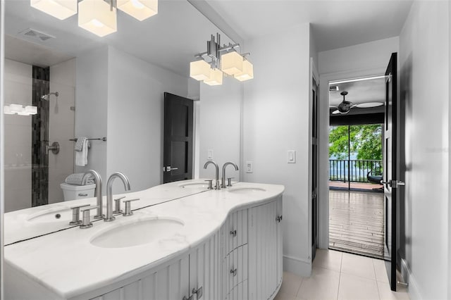 10545 Down Lakeview Cir, Windermere, FL 34786 - full bathroom featuring tile patterned floors, double vanity, a tile shower, and a ceiling fan