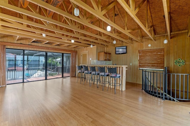 10545 Down Lakeview Cir, Windermere, FL 34786 - kitchen with light wood-style floors, wood walls, and a breakfast bar area