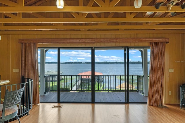 10545 Down Lakeview Cir, Windermere, FL 34786 - entryway with wood walls, a water view, wood-type flooring, a wood stove, and beam ceiling