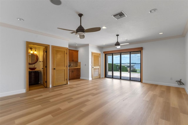 10545 Down Lakeview Cir, Windermere, FL 34786 - unfurnished living room featuring ceiling fan, recessed lighting, crown molding, and light wood-style floors