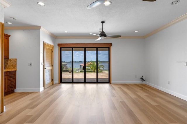 10545 Down Lakeview Cir, Windermere, FL 34786 - spare room with ornamental molding, a ceiling fan, light wood finished floors, a textured ceiling, and recessed lighting