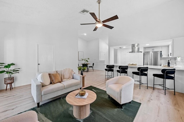 1870 Whispering Way, Tarpon Springs, FL 34689 - living room with high vaulted ceiling, light wood finished floors, ceiling fan, and recessed lighting