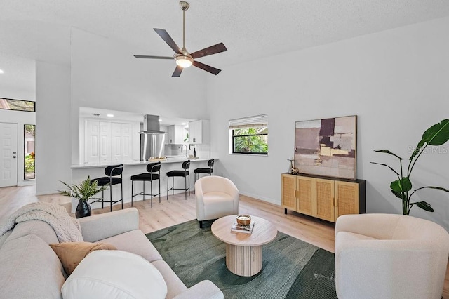 1870 Whispering Way, Tarpon Springs, FL 34689 - living room with light wood-style floors, ceiling fan, recessed lighting, and high vaulted ceiling