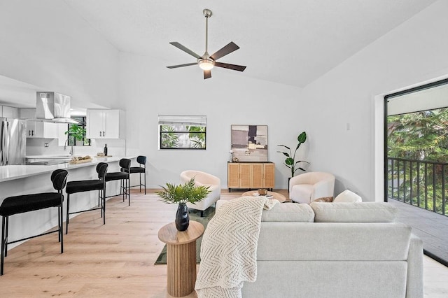 1870 Whispering Way, Tarpon Springs, FL 34689 - living area with plenty of natural light, light wood-style flooring, ceiling fan, and high vaulted ceiling