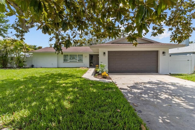 671 25th St SW, Largo, FL 33770 - ranch-style house with an attached garage, concrete driveway, and stucco siding